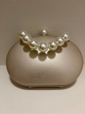 Olga Berg Pearl Handle Clutch in Champagne With Chain shoulder Strap